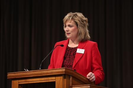 Catherine Kwasigroh, vice president for institutional advancement, welcomes guests to homecoming chapel. - Photo by Kristi McMurry Woody