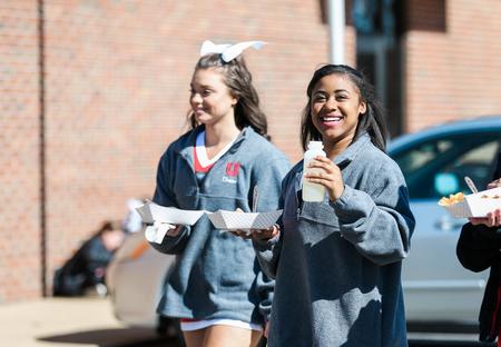 Caroline Sammons, freshman interdisciplinary studies major, and Kelsey Yarbrough, freshman biology major, enjoy the food from Coyote Blues during the tailgating event before the basketball games on February 4.  - Photo by Kristi McMurry Woody