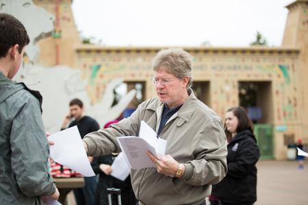 Mark Bolyard, professor of biology and department chair, takes up papers at the beginning of a field trip to the Memphis Zoo. - Photo by Kristi McMurry Woody