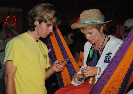 Director of Residence Life Kathy Southall describes the coffee menu to Daniel Schafers during the Hurt Costume Coffee House. - Photo by Amanda Herron