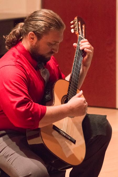 Adjunct professor Aaron Brock performs a faculty guitar recital in Hartley Hall.  - Photo by Gretchen Foels