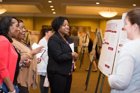 Students present their poster projects to faculty, staff and guests at the annual Scholarship Symposium. - Photo by Kristi McMurry Woody