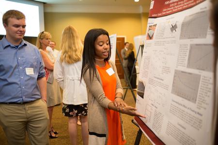 Nyla Gwan, sophomore engineering major, presents her project during the Scholarship Symposium. - Photo by Kristi McMurry Woody