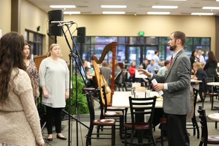 Dan Musselman, associate professor of music and acting chair, leads students in singing during the prayer breakfast in Brewer Dining Hall. - Photo by Kristi McMurry Woody
