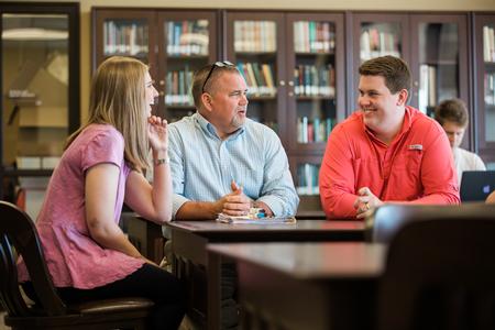 Jessica Vineyard, senior mathematics major, Chris Hail, professor of mathematics, and John Gollihugh, senior mathematics major, meet in the archives room in The Logos. - Photo by Kristi McMurry Woody