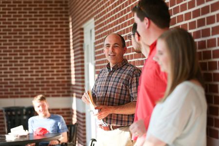 George Moss, associate professor of mathematics and department chair, hands out awards during the department picnic at the end of the year.  - Photo by Kristi McMurry Woody