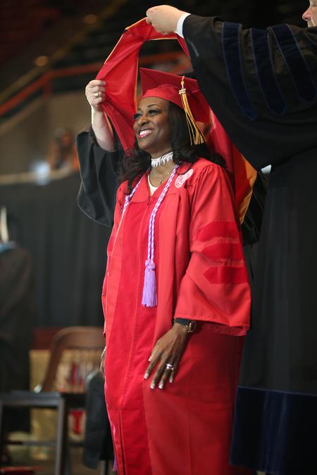 Stacey Labarre-Powell, doctor of nursing practice graduate, receives her doctoral hood during spring commencement.  - Photo by Kristi McMurry Woody