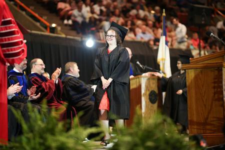 Kelsie Layman, one of the first graduates of the Union EDGE program, walks across the stage to receive her diploma as the entire arena applauds.  - Photo by Kristi McMurry Woody