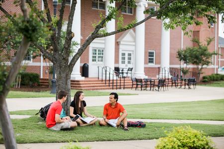 Stephen Neu, junior business administration major, Amelia Kangas, freshman TESL major, and Binh Morris, sophomore business administration major, chat outside the Bowld Student Commons. - Photo by Kristi McMurry Woody