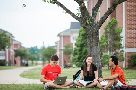 Stephen Neu, junior business administration major, Amelia Kangas, freshman TESL major, and Binh Morris, sophomore business administration major, chat outside the Bowld Student Commons. - Photo by Kristi McMurry Woody