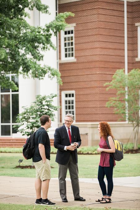 Trenton Holloway, junior psychology major, Greg Jordan, professor of business law and ethics, and Mattanah DeWitt, freshman journalism major, talk outside The Logos on a nice spring day.  - Photo by Kristi McMurry Woody