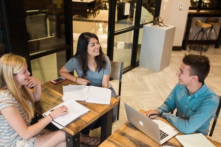 Callie Hauss, freshman nursing major, Todosita Torres, sophomore business major, and Gavin Hamann, freshman engineering major enjoy some free time in Modero. - Photo by Kristi McMurry Woody