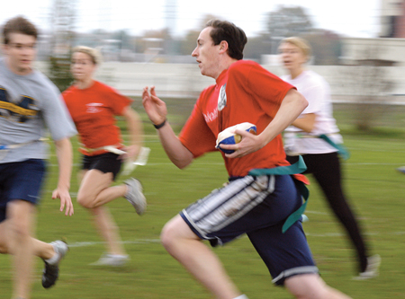 Sophomore David Roach, broadcasting major, leads his "Stuffers" teammates to the endzone in their game
against "Gravy," at the Young Alum sponsored second annual sophomore class Turkey Bowl event, Nov. 20. - Photo by Kristen Hiller