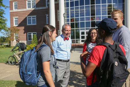 Dub Oliver, president of the university, chats with students outside The Logos on a nice day.  - Photo by Kristi McMurry Woody
