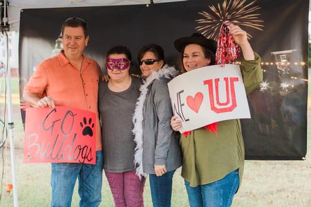 Students take photos with family members in the Residence Life booth during Union Night on the Great Lawn. - Photo by Kristi McMurry Woody
