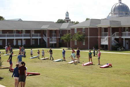 Students and their families participate in a corn hole tournament during Family Weekend.  - Photo by Kristi McMurry Woody