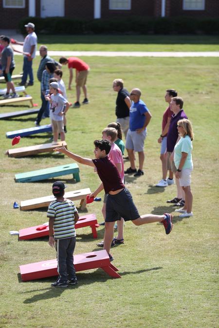 Residence Life hosts families for a corn hole tournament on the Bowld Commons lawn during Family Weekend. - Photo by Kristi McMurry Woody