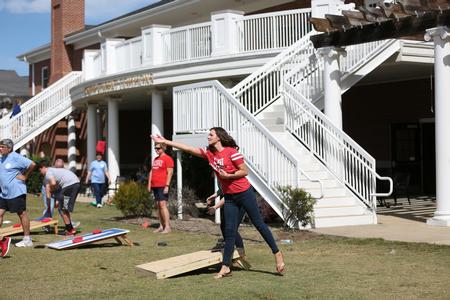 Students and their families enjoy a corn hole tournament in the Grace Quad during Family Weekend. - Photo by Kristi McMurry Woody