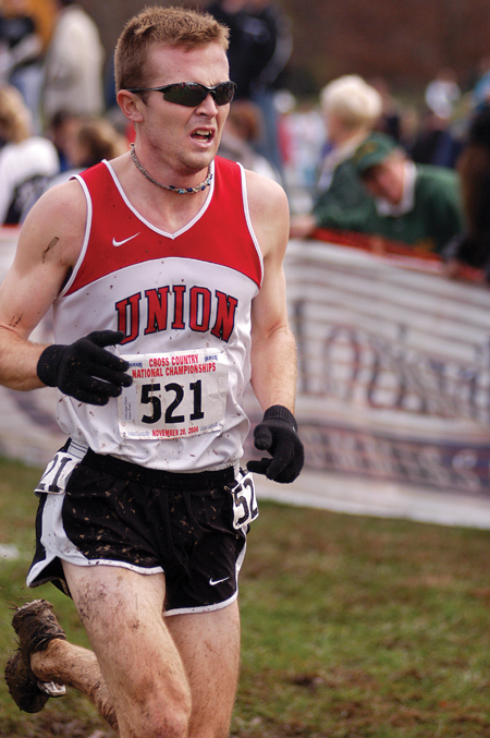 Senior Chris Winter, history major, braves
the cold, muddy conditions in order to finish the race for nationals. - Photo by Kristen Nicole Sayres