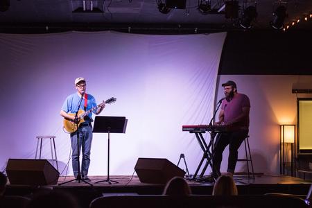 Josh Mays, conservation biology major, and Shae McCollough, English major, perform at the office of university ministries event, "Songs and Stories."  - Photo by Janelle Vest