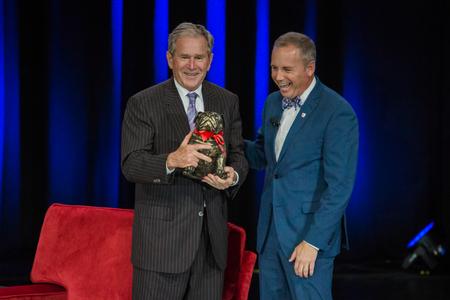 Dub Oliver (right), president of the university, presents George W. Bush, 43rd president of the United States, with a bulldog sculpted by art student Song Kim at the conclusion of the 43rd annual Scholarship Banquet.  - Photo by Kristi McMurry Woody