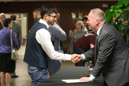Jacob Shatzer, associate dean of the school of theology and missions, shakes hands with Dr. Bruce Gordon, the Titus Street Professor of Ecclesiastical History at Yale Divinity School, following the annual Carls-Schwerdfeger History Lecture. - Photo by Kristi McMurry Woody