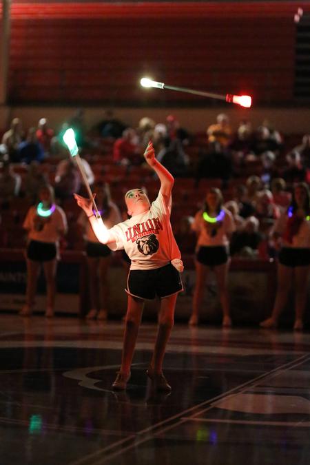 Ali Keck, psychology major, twirls batons at the beginning of Bulldog Madness.  - Photo by Kristi McMurry Woody