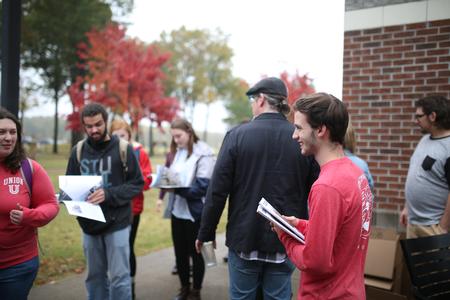 Cardinal & Cream staffers hand out the most recent edition of the magazine during homecoming weekend. - Photo by Kristi McMurry Woody
