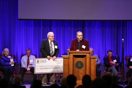 Members of the class of 1967 present a check for a scholarship during homecoming chapel. - Photo by Kristi McMurry Woody