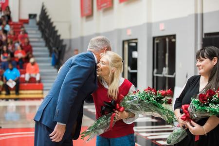 Dub Oliver, president of the university, presents the Blackstock family with flowers in memory of the late David Blackstock. - Photo by Kristi McMurry Woody
