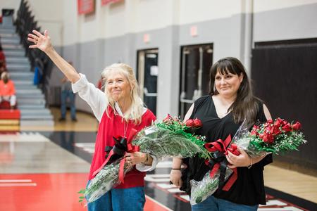 Dub Oliver, president of the university, presents the Blackstock family with flowers in memory of the late David Blackstock. - Photo by Kristi McMurry Woody