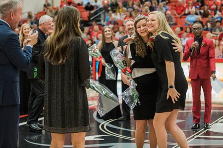 Mary Byars, new homecoming queen, gets a hug from former homecoming queen Kelly Gwartney McCormack. - Photo by Kristi McMurry Woody