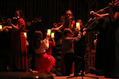 The children's choir holds candles up to light the strings piece during the A Union Christmas concert.  - Photo by Kristi McMurry Woody