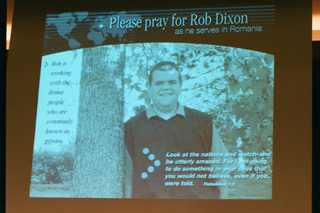 Students are asked to pray for alum Rob Dixon, a journeyman in Romania, at the GO Week Chapel 2002. - Photo by Justin Veneman