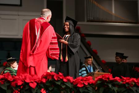 Deidrea Houston, organizational leadership graduate, receives her diploma during fall graduation. - Photo by Kristi McMurry Woody