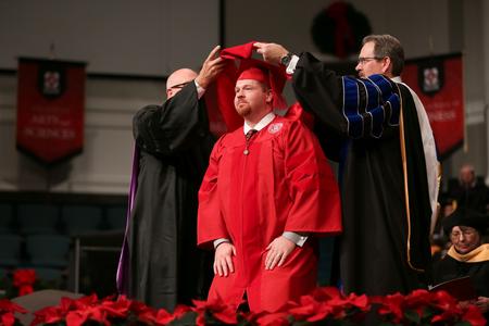 Tyler Campbell, doctor of ministry graduate, receives his doctoral hood during fall graduation. - Photo by Kristi McMurry Woody