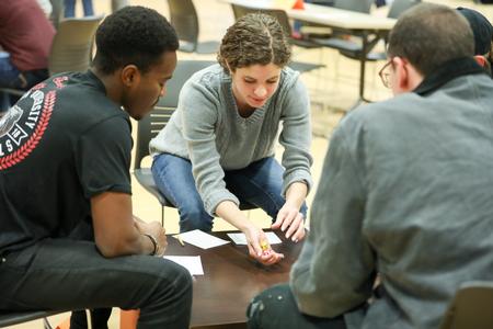 Karis Lancaster, senior English with honors major, plays in the Residence Life Bunco tournament with her fellow students during January term. - Photo by Kristi McMurry Woody