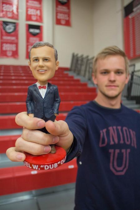 John David Logan, sophomore political science major, holds up a Dub bobblehead before the game starts. - Photo by Riley Boggs