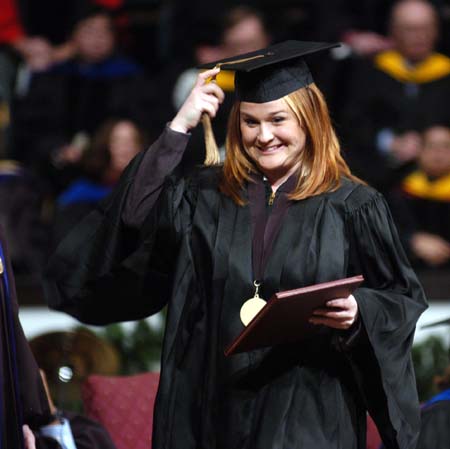 An excited Laura Bush, marketing graduate from Jackson, moved her tassle after receiving her diploma at fall graduation. - Photo by Morris Abernathy