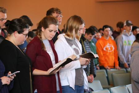 Students follow along with the scripture reading at the beginning of chapel. - Photo by Hannah Heckart