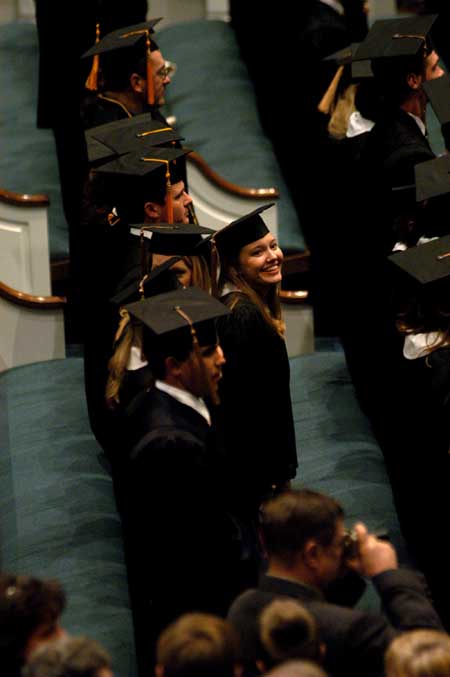 Marketing graduate Carly Findley flashes a big smile up to family and friends during fall graduation 2004. - Photo by Kristen Nicole Sayres