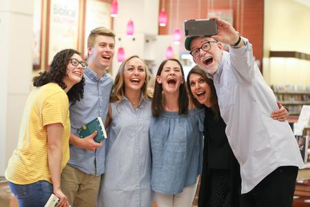 Bob Goff (far right) and his wife Maria pose with students during a book signing in Lifeway Christian Store. - Photo by Kristi McMurry Woody