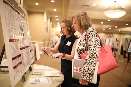 Meredith Tatarzycki, doctor of nursing practice student, presents her research at the Scholarship Symposium. - Photo by Kristi McMurry Woody