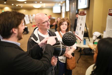 Paul Mayer, director for health services, checks out one of the engineering projects during the Scholarship Symposium. - Photo by Kristi McMurry Woody