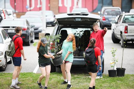 Students carry trees to the spots where they will be planted for the Union University Arboretum.  - Photo by Kristi McMurry Woody