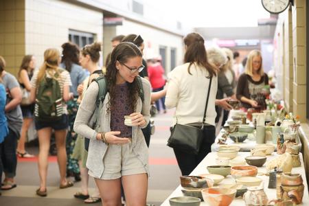 Students and employees browse the Mother's Day Pottery Sale in the SUB Hallway. - Photo by Kristi McMurry Woody