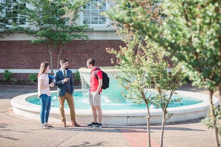 Jacob Shatzer (center), associate dean of the school of theology and missions, chats with Haley Hathcock, biology major, and Eli Creasy, art major, outside Jennings Hall. - Photo by Kristi McMurry Woody