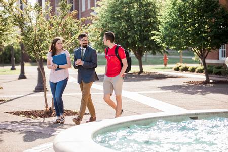 Jacob Shatzer (center), associate dean of the school of theology and missions, chats with Haley Hathcock, biology major, and Eli Creasy, art major, outside Jennings Hall. - Photo by Kristi McMurry Woody