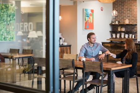 Casper Nyberg, business administration major, and Emily Lean, associate professor of management, chat in Modero. - Photo by Kristi McMurry Woody