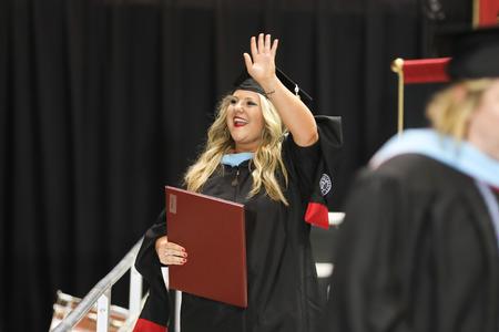 Mollie Abell, master of urban education, celebrates after receiving her diploma at spring commencement services.  - Photo by Kristi McMurry Woody